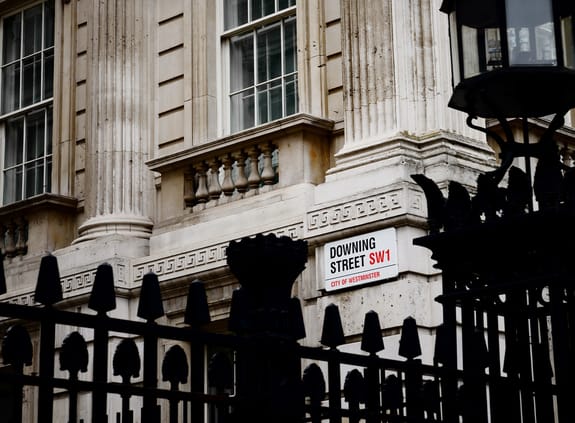Downing Street road sign on the side of a building
