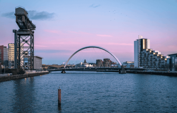A bridge across the river in Glasgow at sunset