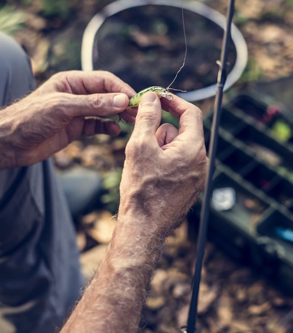 Practiced hands prepare a fishing lure