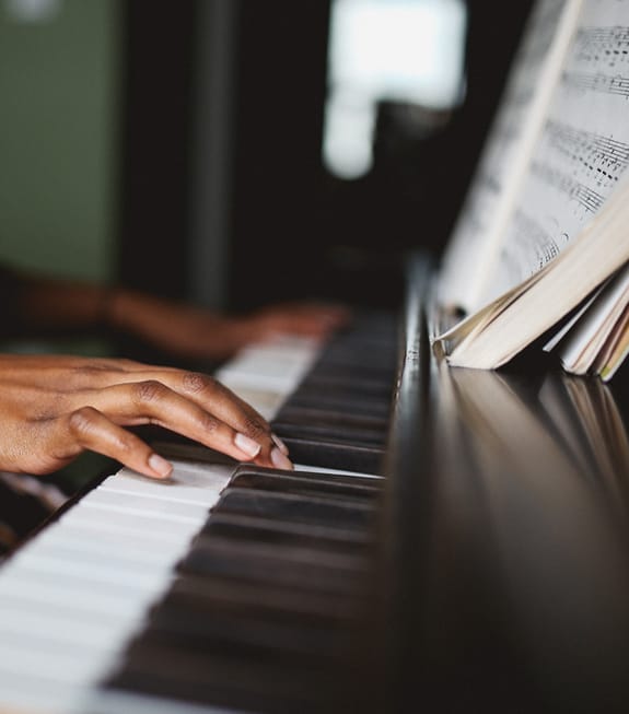 Close-up of a hand playing piano