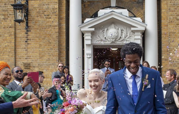 Newlyweds being celebrated walking out of wedding ceremony