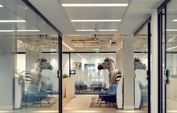 Statue of a zebra reflected in Investec's London office windows