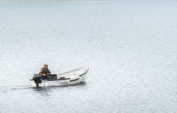 Old man boating out on the water