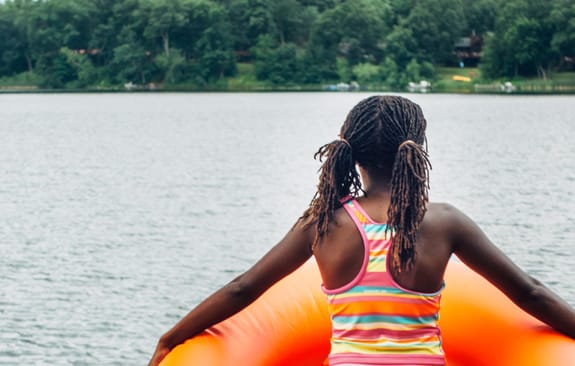 Young girl in an orange inflatable ring