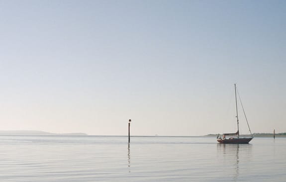 A lone sailboat on calm waters