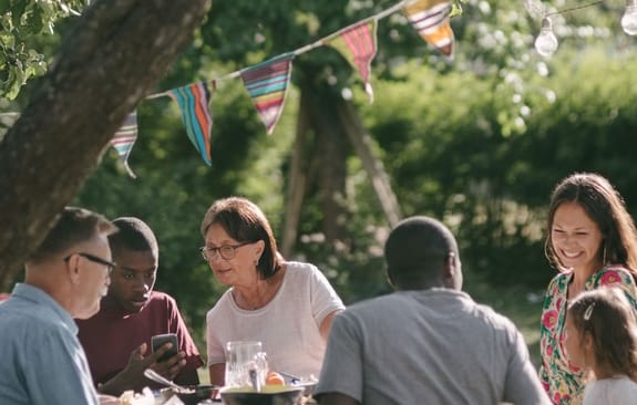 Family sharing a meal together outside