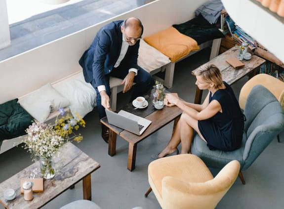 Two business people have a meeting over coffee in a cafe