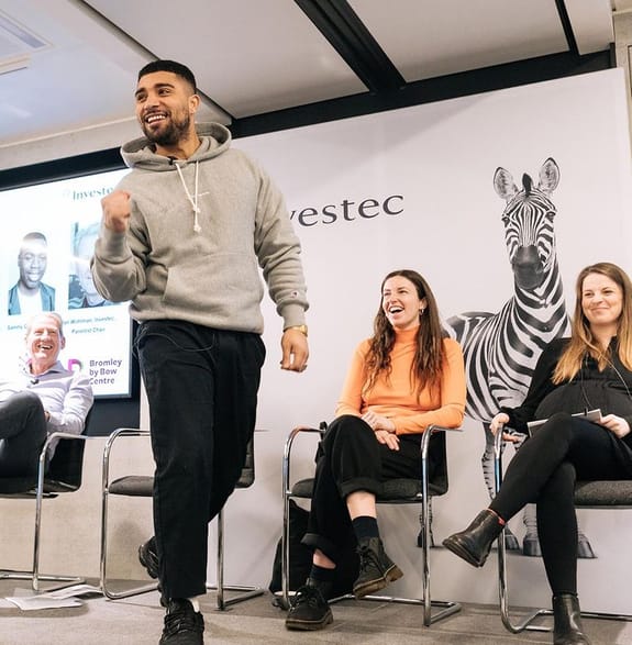 An Investec employee making an audience laugh
