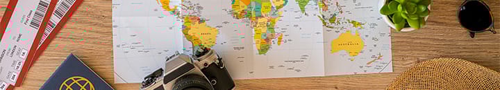Map with pin points and laptop researching