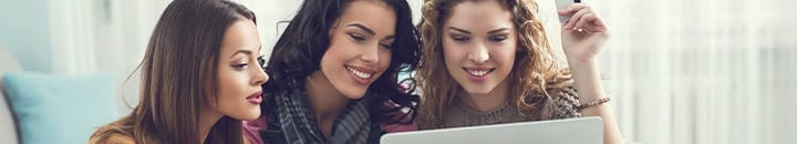Female friends shopping online together