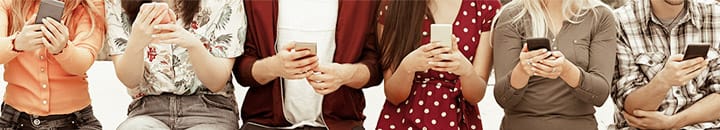 row of people all checking their social media on mobile phones