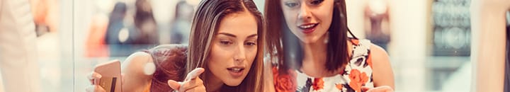 Young females looking at shop window