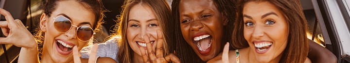 Female friends enjoying their break away in their car
