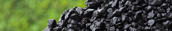 Pile of lumps of coal with green background