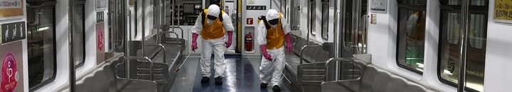 Disinfection workers wearing protective gear spray anti-septic solution against the coronavirus (COVID-19) in an subway at Seoul metro railway base
