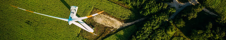 Aerial view of a wind turbine and cultivated fields