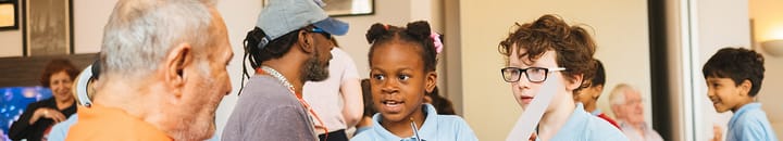 Primary school children visiting a retirement home to take part of educational activities and build links with senior members of their community.