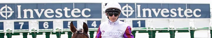 Jockey infront of the starting line with Investec signs displaying above