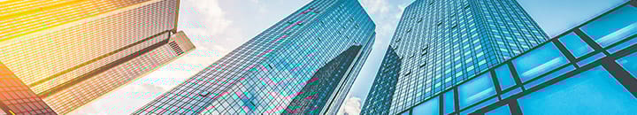 modern office towers with sunlight hitting one of the towers