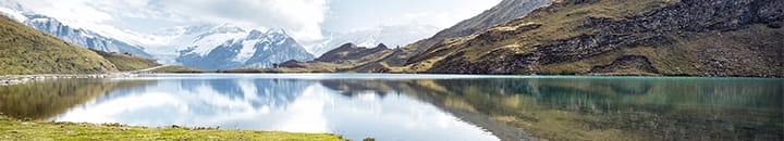 Snow capped mountains in the background of a lake