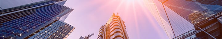 Looking up at office buildings with sunset