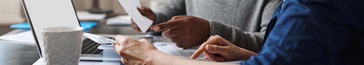 Couple looking at finances on laptop
