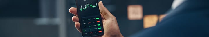 Business man checking stocks on mobile
