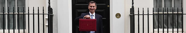 Chancellor Jeremy Hunt standing outside number 11 Downing Street with the red box