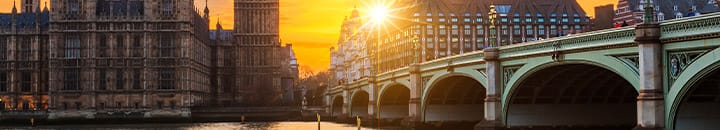 Westminster bridge and houses of parliament with sunsetting in background