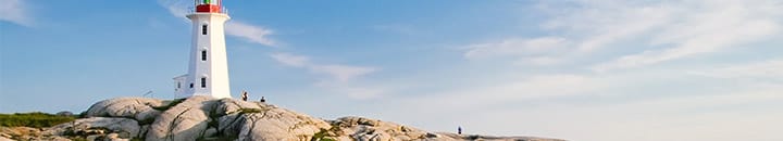 Lighthouse by cliff face near beach
