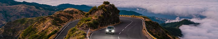 SUV driving on hairpin road in mountains