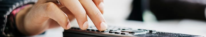 Hand using calculator