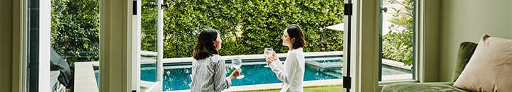 Two females enjoying a drink outside in their garden