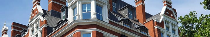 Close up of top section of old corner town house
