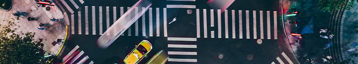 Cross roads in the middle of a busy city centre from above