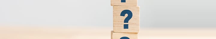 Wooden blocks with question marks on them