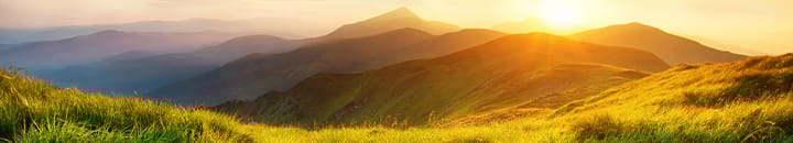 Sun rising over hills