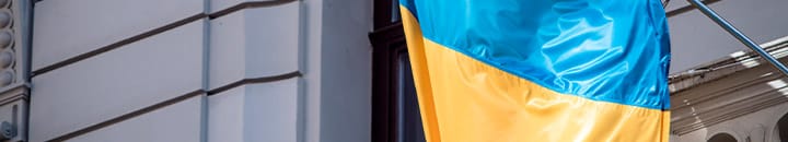 Ukraine flag hanging outside a building