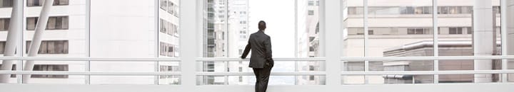 Male staring at building architecture