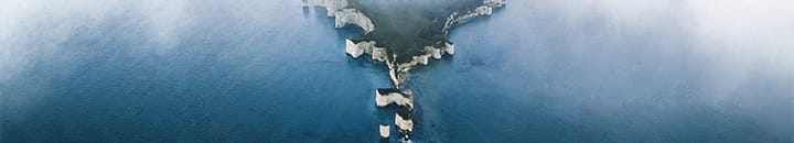 View of coastline from above with mist around