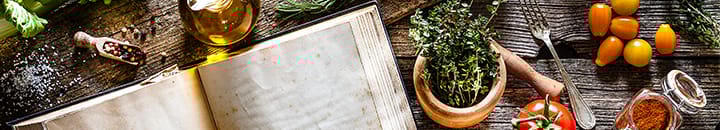 cook book with ingredients on a wooden table