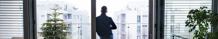 A man looking out at the view from his new property, secured with a buyers agent.
