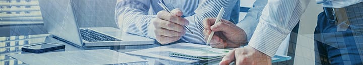 Businessmen working together over paperwork