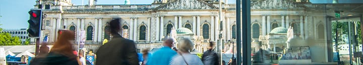 Shoppers walking by Belfast city hall