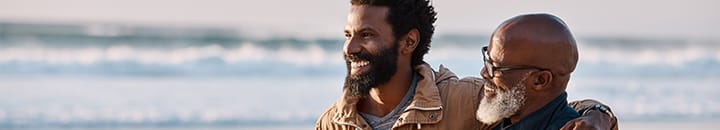 Shot of a young man going for a walk along the beach with his father