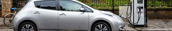 electric car charging on a road