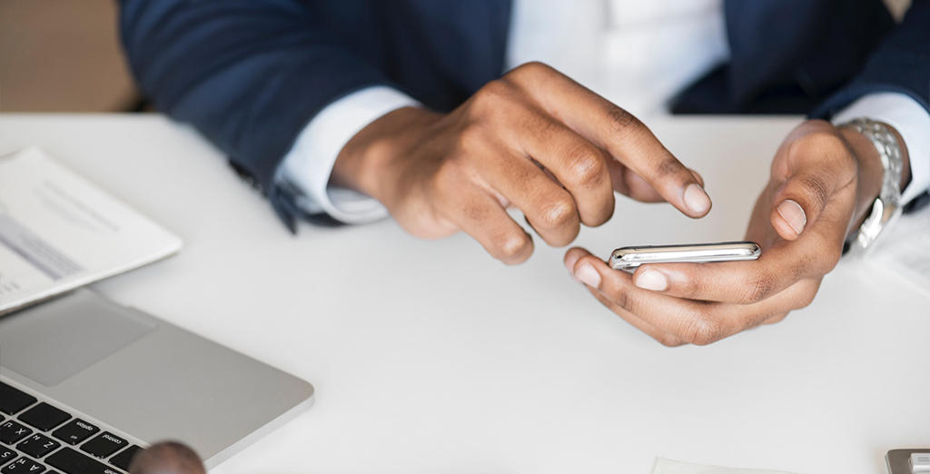 Businessman accessing his mobile phone