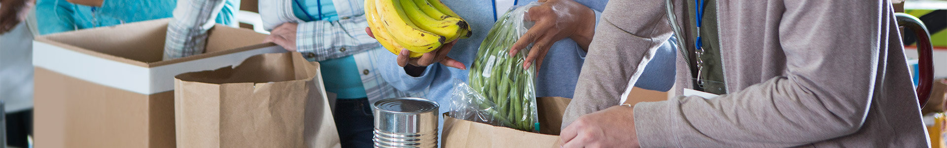 Volunteers packing food into bags at a food bank