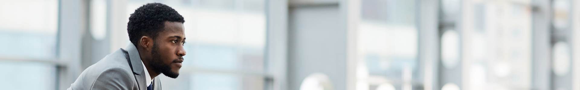 Business man staring out over office