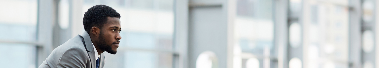 Business man staring out over office